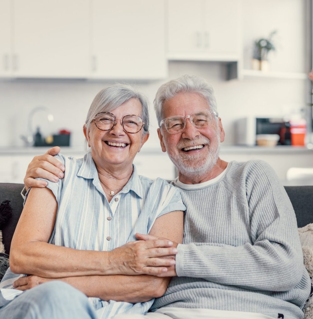 Happy,Mature,Husband,And,Wife,Sit,Rest,On,Couch,At